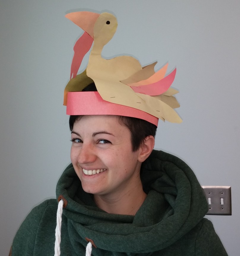 Sue wearing a paper hat shaped like a turkey.