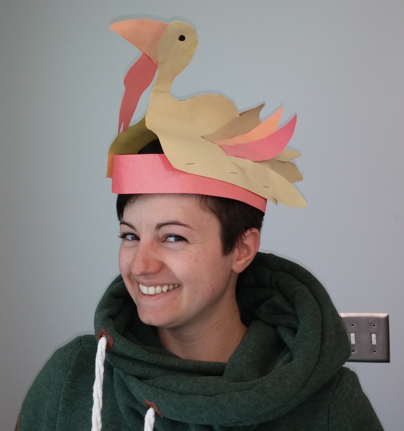 Sue wearing a paper hat shaped like a turkey.