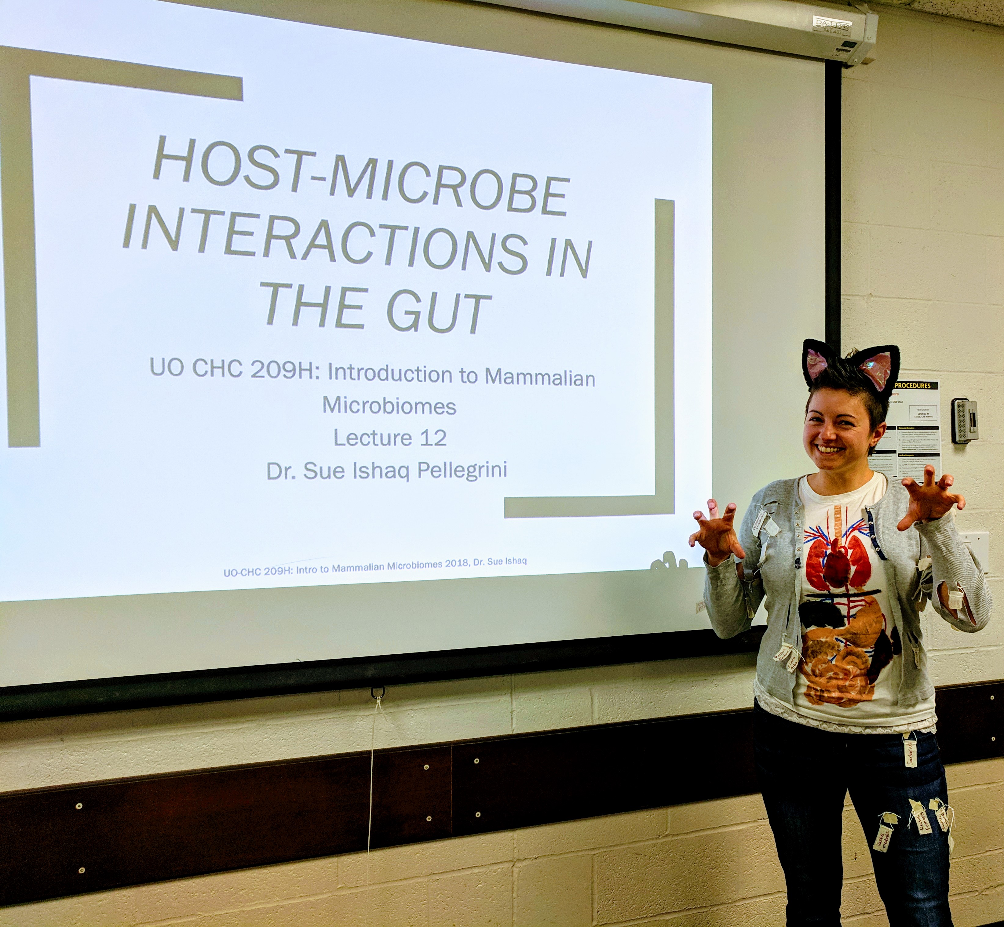 Woman dressed in a costume of a dissected cat, to teach a class on Halloween.