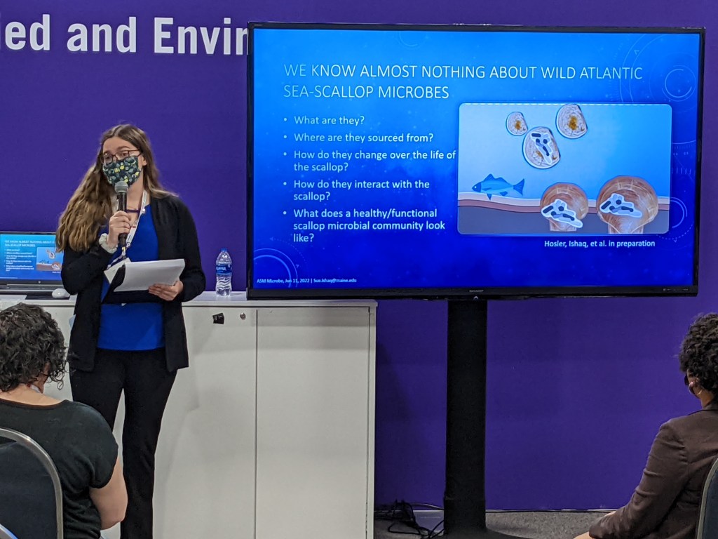 Sarah Hosler presentating a slide of questions about the microbes that associate with scallops