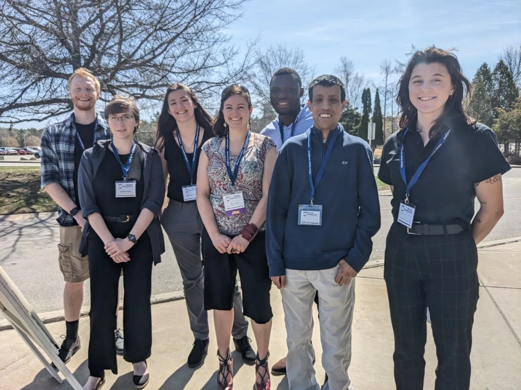 Members of the Ishaq Lab posing together for a photo outside.